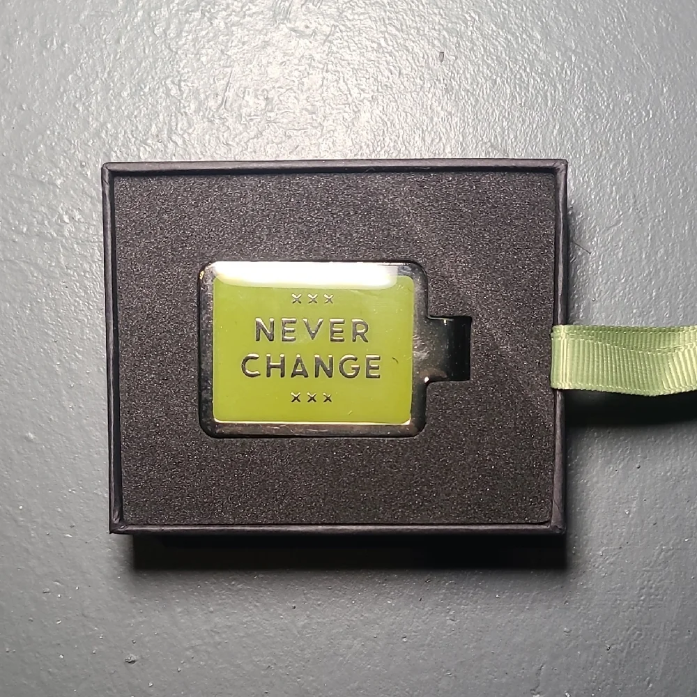 Green Keychain with 'Never Change' Inscription